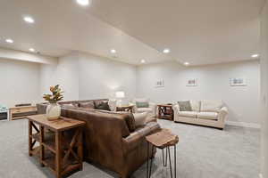 Carpeted living room featuring recessed lighting and two-tone paint