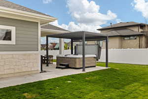 View of yard featuring a patio, a fenced backyard, and a hot tub