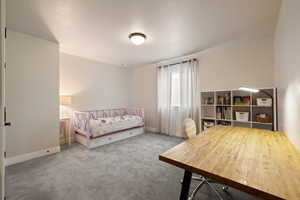 Bedroom featuring light carpet flooring and two-tone paint
