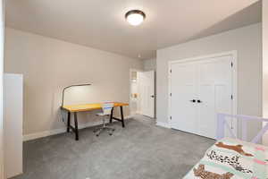 Bedroom featuring light carpet flooring and two-tone paint