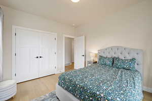 Spare bedroom featuring light hardwood floors, two-tone paint