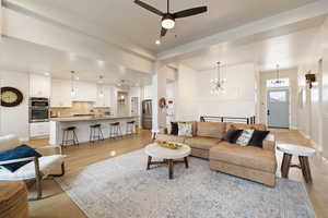 Living room featuring light hardwood floors, recessed lighting, and two-tone paint