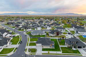 Aerial view at dusk featuring a mountain view and a residential view