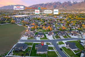 Aerial view at dusk featuring a mountain view and a residential view