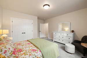 Bedroom featuring light carpet flooring and two-tone paint