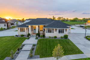 View of front of house featuring fence, a front lawn, and stone siding