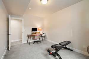 Bedroom featuring light carpet flooring and two-tone paint