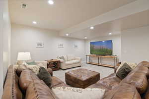 Carpeted living room featuring recessed lighting and two-tone paint