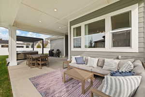 View of patio / terrace featuring an outdoor hangout area, fence, and a hot tub
