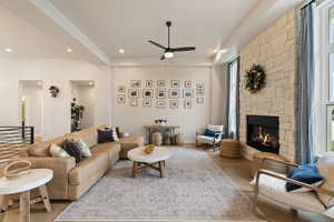 Living area featuring recessed lighting, a ceiling fan, and a stone fireplace