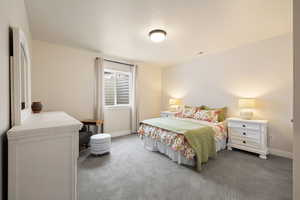 Bedroom featuring light carpet flooring and two-tone paint
