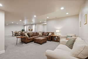 Carpeted living room featuring recessed lighting and two-tone paint