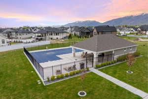 View of swimming pool with a lawn and a residential view