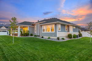 Prairie-style house featuring a fenced backyard, a covered patio, cement-fiber siding and light colored stone