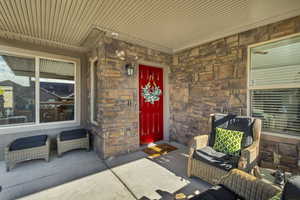 Entrance to property featuring stone siding