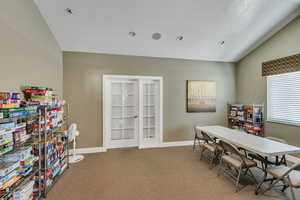 Office space with recessed lighting, baseboards, light carpet, and lofted ceiling