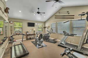 Workout room with a ceiling fan, baseboards, vaulted ceiling, and recessed lighting