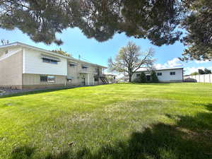 View of this functional yard, shop, patio, and deck
