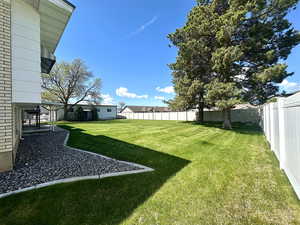 View of yard with a park-like setting and a fenced backyard