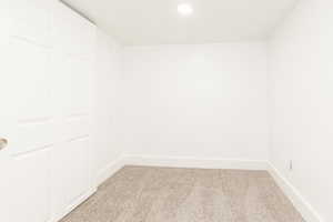 Unfurnished room with recessed lighting, baseboards, and light carpet