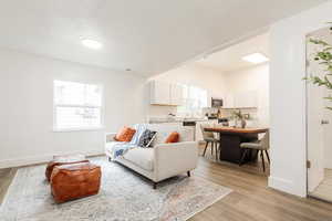 Living room with light wood finished floors and baseboards