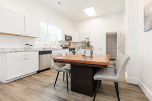 Dining room featuring baseboards, visible vents, and light wood-style flooring