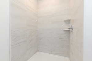 Bathroom featuring tiled shower