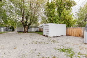 View of yard featuring an outdoor structure, a shed, and a fenced backyard