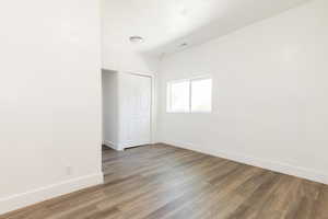 Unfurnished room featuring baseboards and wood finished floors