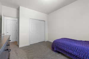 Carpeted bedroom featuring baseboards