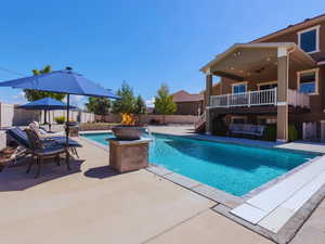 View of swimming pool featuring a fenced backyard, a fenced in pool, stairs, and a patio area