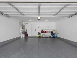 Garage with a garage door opener and secured water heater
