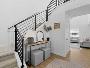 Stairs with baseboards and wood finished floors