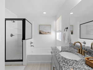 Full bathroom with vanity, a stall shower, recessed lighting, and a bath