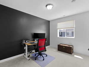 Carpeted bedroom featuring baseboards, and visible vents