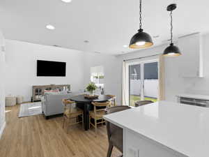 Dining area featuring recessed lighting, light wood finished floors, and visible vents