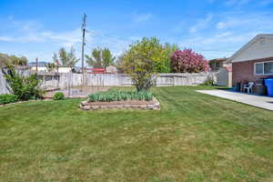 View of yard featuring a fenced backyard and a patio