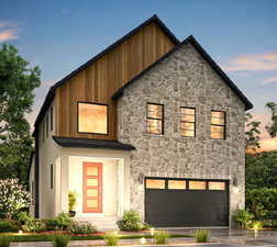 Contemporary house with a garage, aphalt driveway, and stone siding