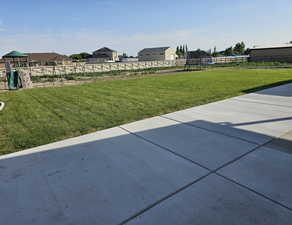 View of yard featuring a trampoline, a patio area, and a playground