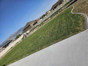 View of grassy yard with a mountain view