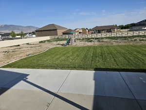 View of yard with a playground, a patio area, and a residential view