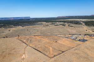 Aerial view featuring view of desert and a rural view