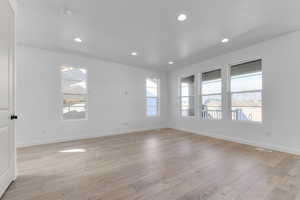 Unfurnished room featuring light wood-style floors, recessed lighting, baseboards, and visible vents