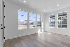 Empty room featuring recessed lighting, baseboards, and light wood finished floors