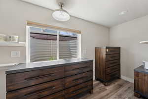 Bedroom featuring wood finished floors and baseboards