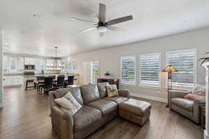 Living area with recessed lighting, a ceiling fan, hardwood / wood-style flooring, and baseboards