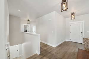 Entryway featuring baseboards and wood finished floors