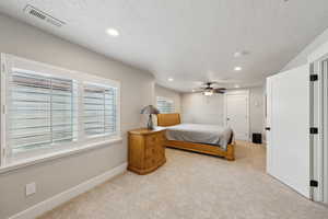 Bedroom featuring a textured ceiling, carpet flooring, visible vents, baseboards, and recessed lighting
