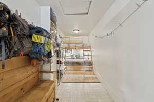 Storage area featuring attic access