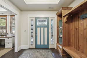 Mudroom with a sink, baseboards, dark wood finished floors, and visible vents